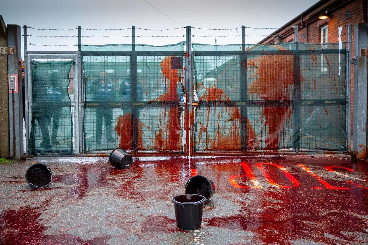 Activists threw fake blood at the gates of Napier while calling for its closure. Photo: Andrew Aitchison/In pictures via Getty Images