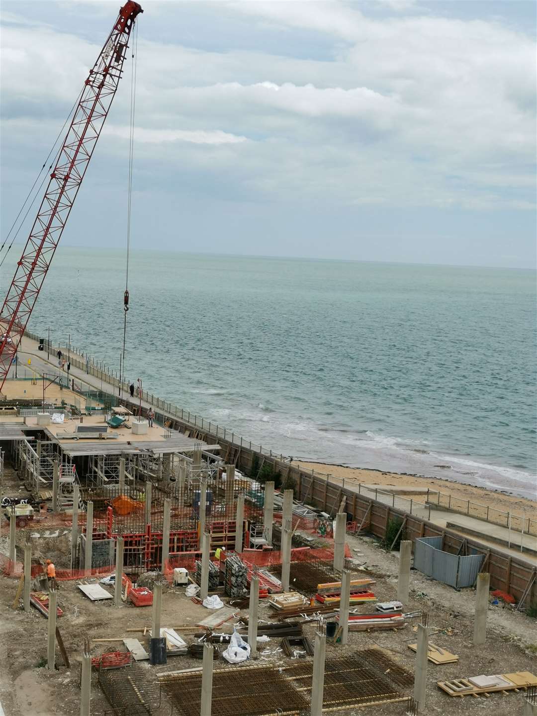 A crane and workmen are seen working on the site