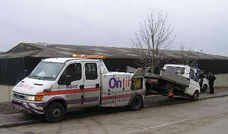 A truck is removed from the area by police officers