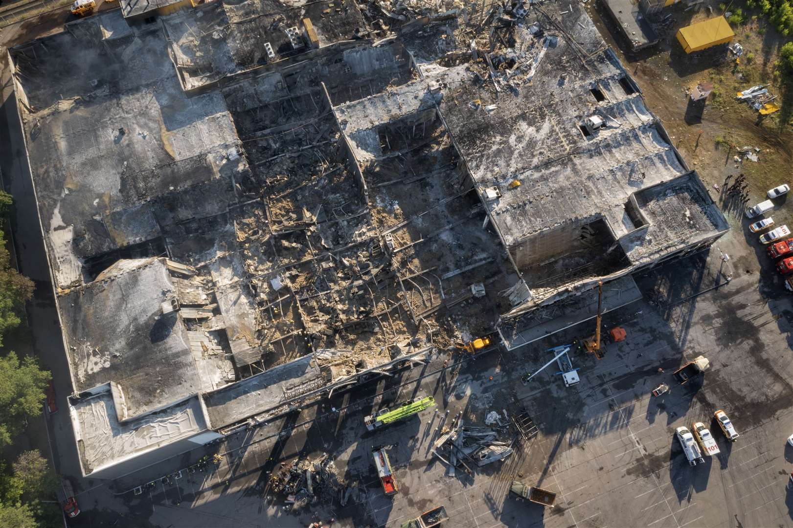 Ukrainian state emergency service firefighters work to take away debris at the shopping centre (Efrem Lukatsky/AP)