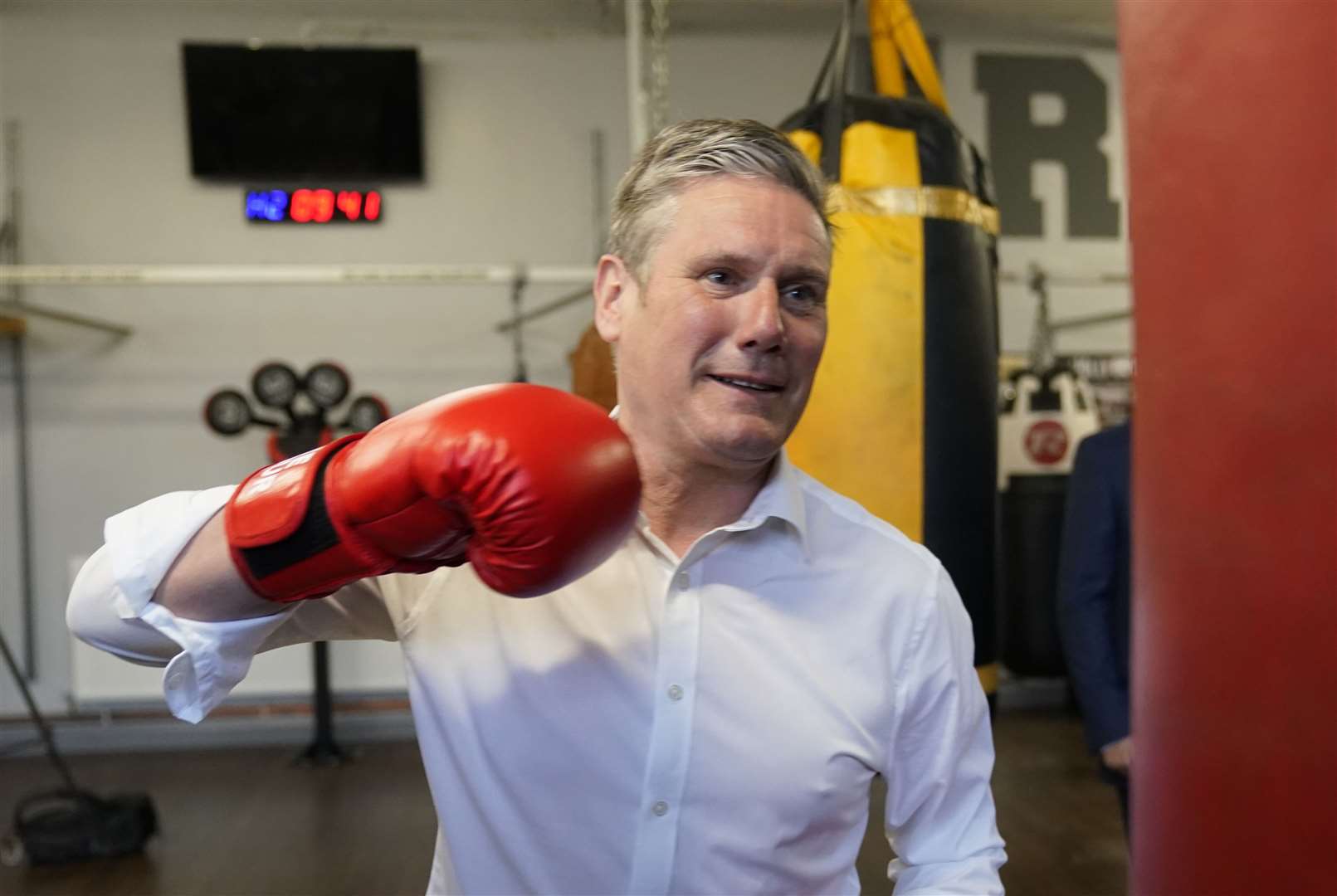 Sir Keir takes aim at a punchbag (Owen Humphreys/PA)