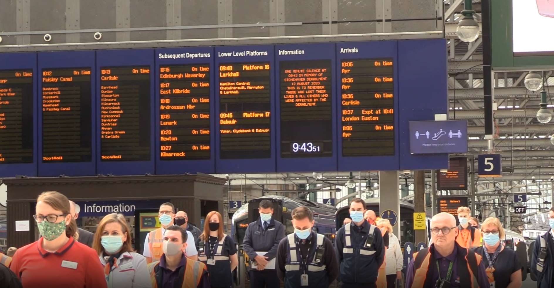 Rail staff, emergency service workers and passengers observe the minute’s silence at Glasgow Central Station (Douglas Barrie/PA)