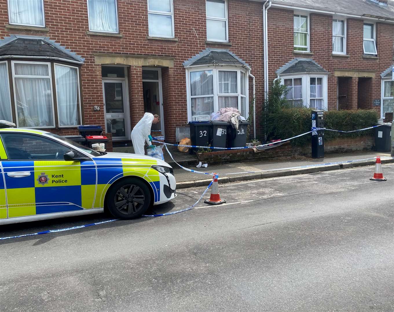 Forensics investigating St Martin's Road, Canterbury, after a woman was charged with murder following the discovery of human remains at a property