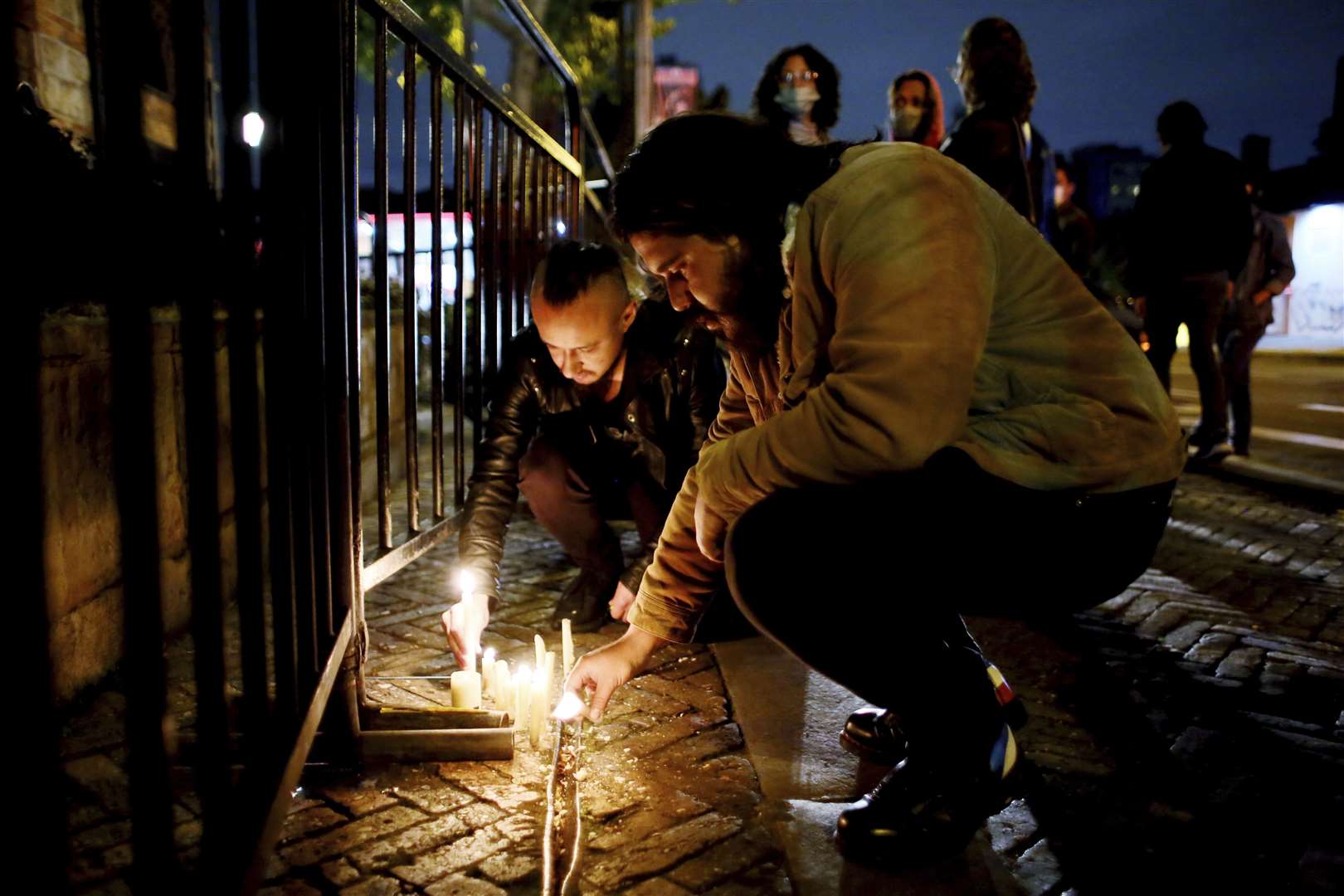 Fans of US band Foo Fighters place lights in front of the hotel where the band’s drummer Taylor Hawkins was found dead in Bogota, Colombia (Leonardo Munoz/AP)