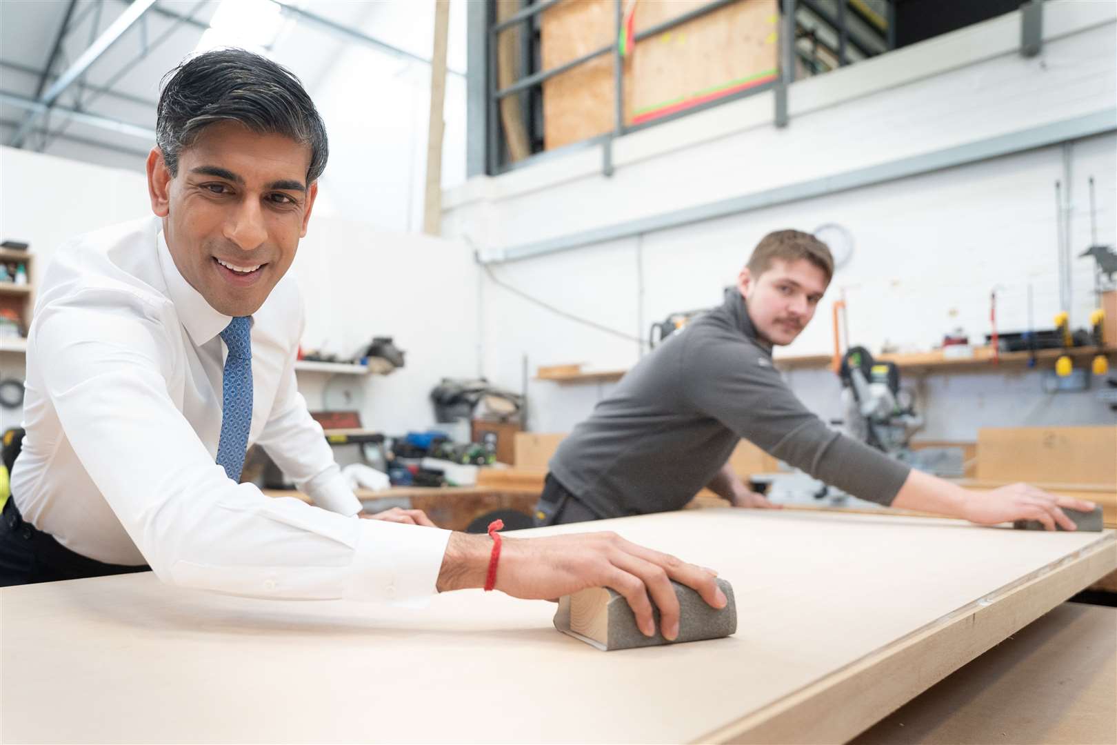 Prime Minister Rishi Sunak got stuck in and helped to make a wooden door at Pinewood Studios with carpenter Adam Jellis (Stefan Rousseau/PA)