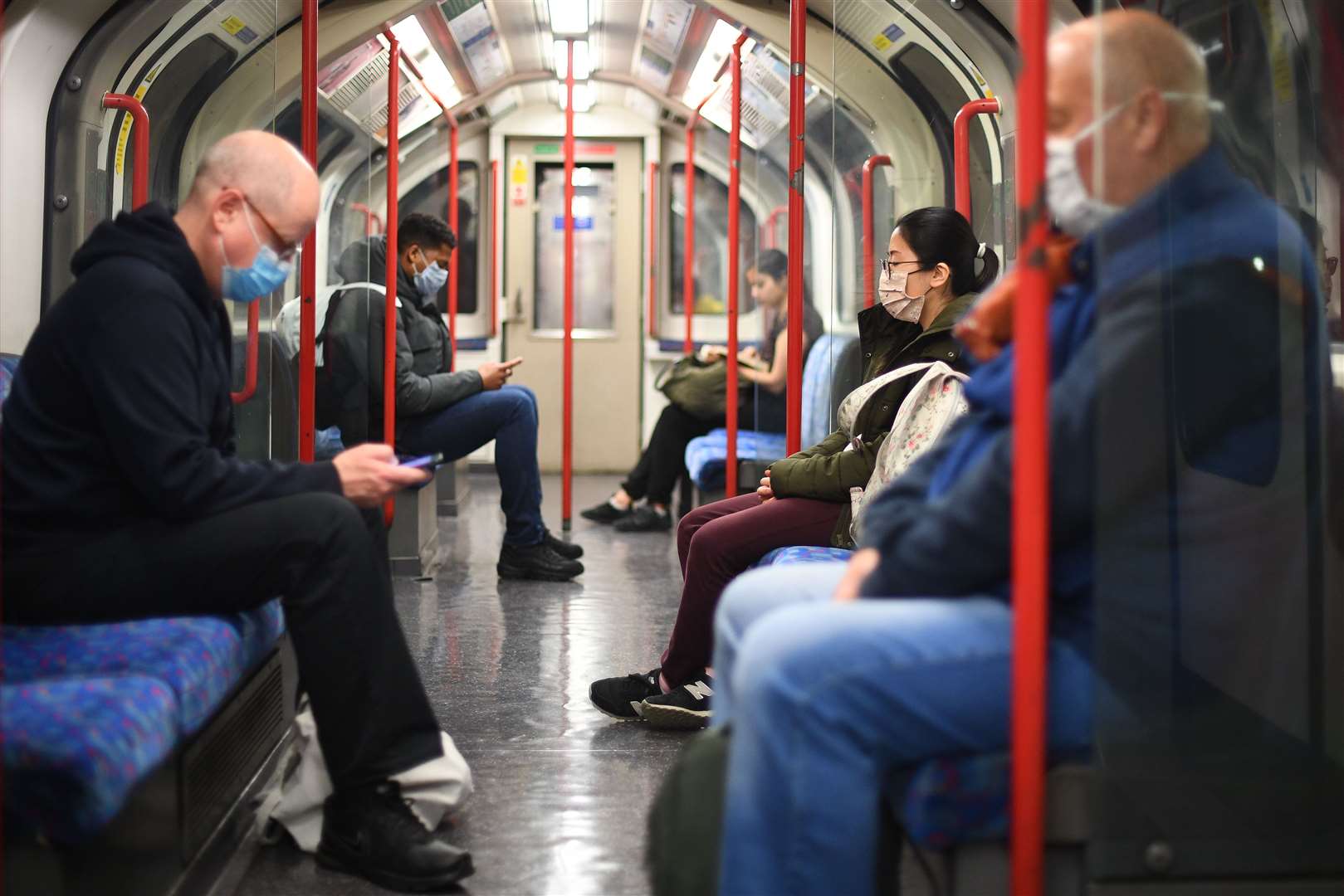 Passengers wear face masks on a Central Line underground train in London (Victoria Jones/PA)