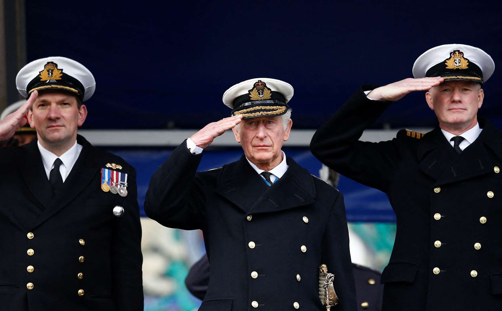 The Prince of Wales, centre, with Captain Roger Readwin, commander of the BRNC, and parade commander, Commander Will Peters (Peter Nicolls/PA)