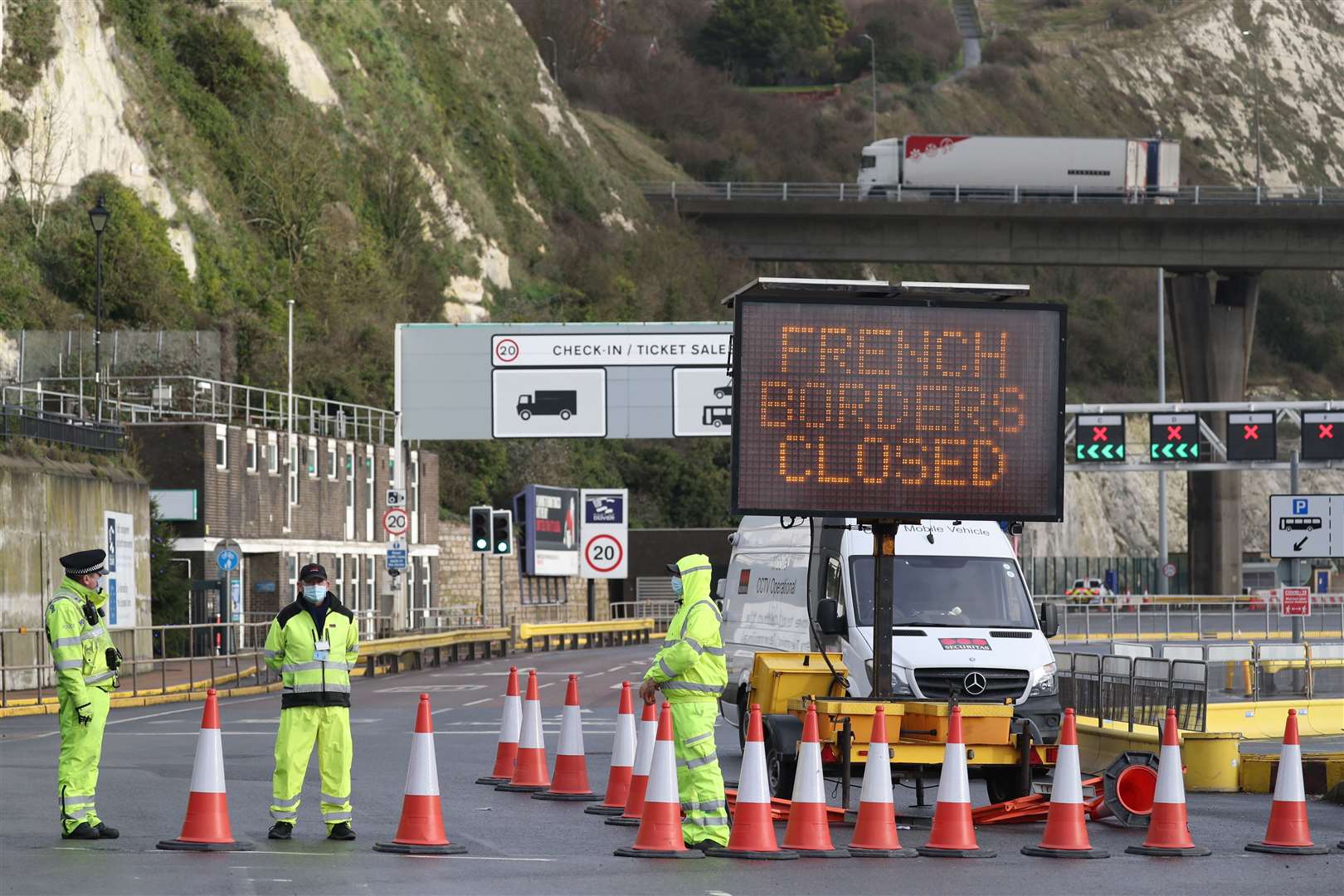 Police officers stand near to a matrix sign notifying that French borders are closed at the entrance to the Port of Dover in Kent. (Andrew Matthews/PA)