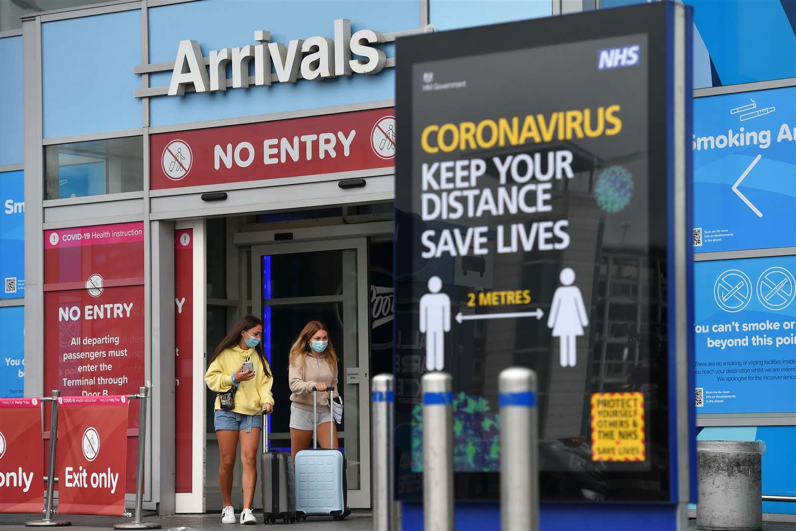 Passengers at Birmingham Airport, as people arriving into England from holidays in Spain have been told they must quarantine when they return home (Jacob King/PA)