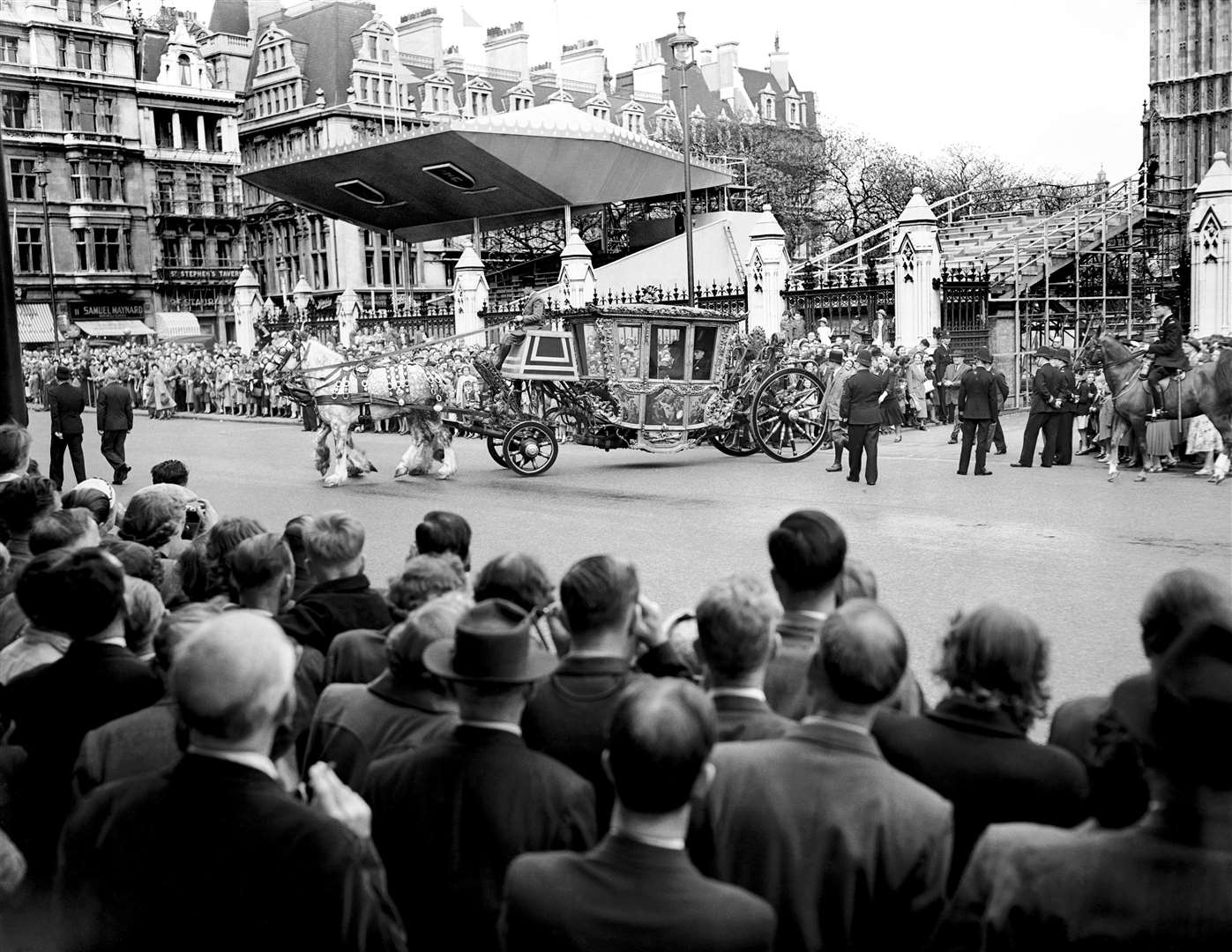 Crowds watching the Speaker’s coach leave the Houses of Parliament for Westminster Abbey, for a Coronation rehearsal (PA)