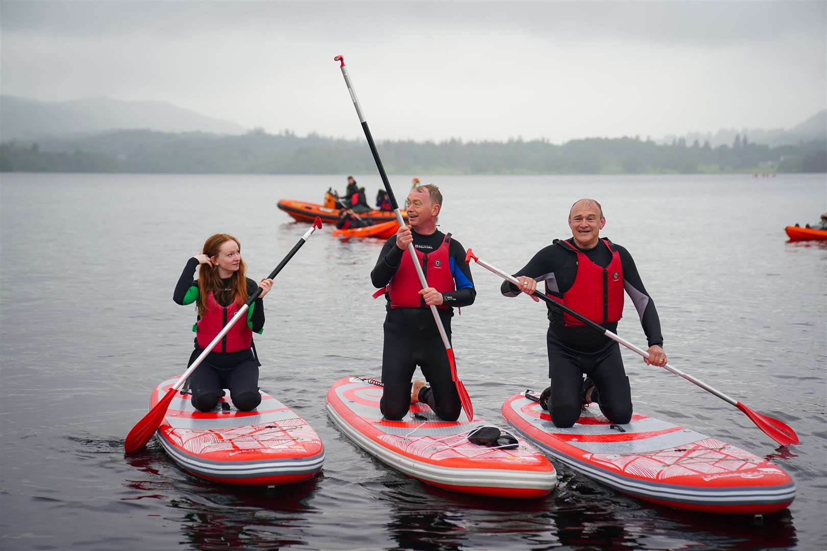 Liberal Democrat leader Sir Ed Davey (right) paddleboards on Windermere with Westmorland and Lonsdale MP Tim Farron and his daughter Gracie (Peter Byrne/PA)