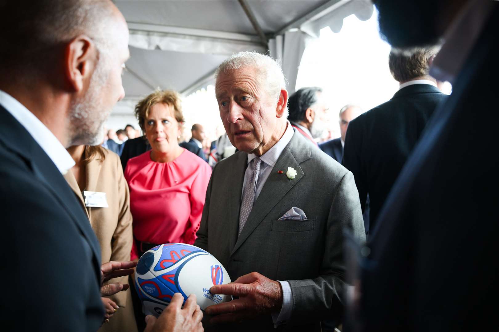 Charles took part in a challenge throwing a rugby ball through a hole (Daniel Leal/PA)