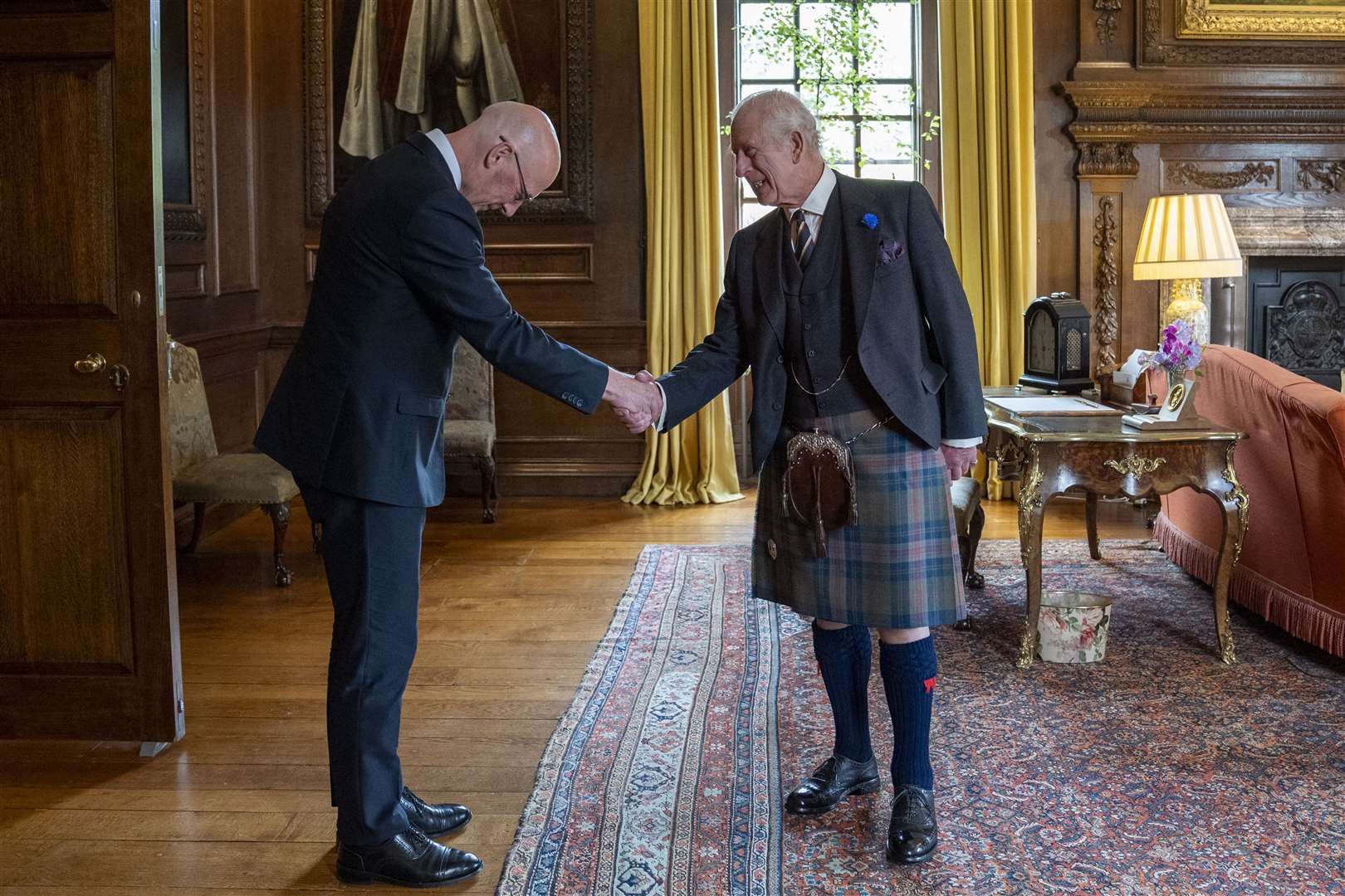 First Minister John Swinney bows to the King on Wednesday (Jane Barlow/PA)