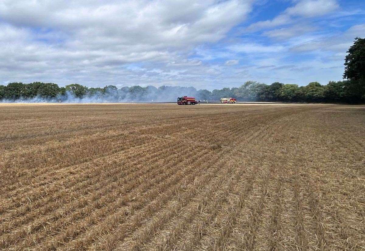 Firefighters dealing with the blaze in the field off Bedsall Road, Paddock Wood. Picture: Charley Goddard