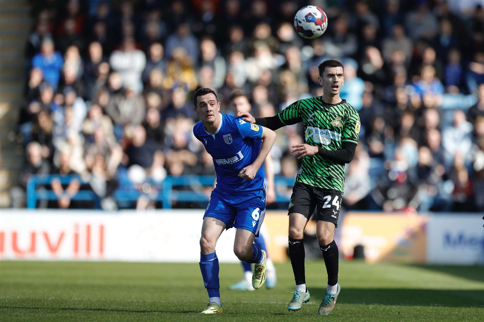 Shaun Williams challenges Zain Westbrooke for the ball as Gillingham take on Doncaster