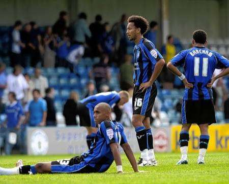 Gillingham players are confused and dejected after the game.
