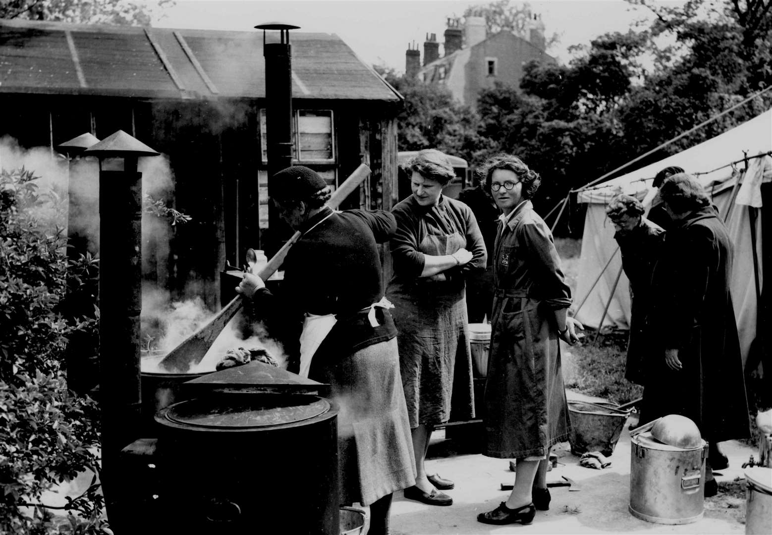 Women Civil Defence volunteers from the Bridge-Blean area prepare stew in May 1955 in a compound behind the municipal buildings at Canterbury (then at Dane John) for an exercise involving 50 men. It was served in a gravel pit at Bigberry Woods, Chartham Hatch