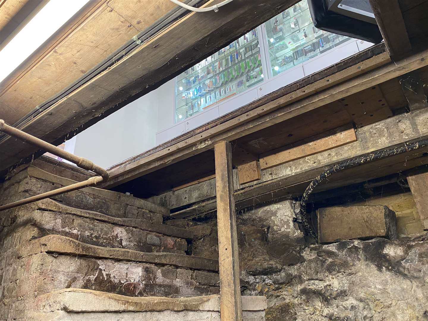 A heavy trapdoor is used to access the underground room