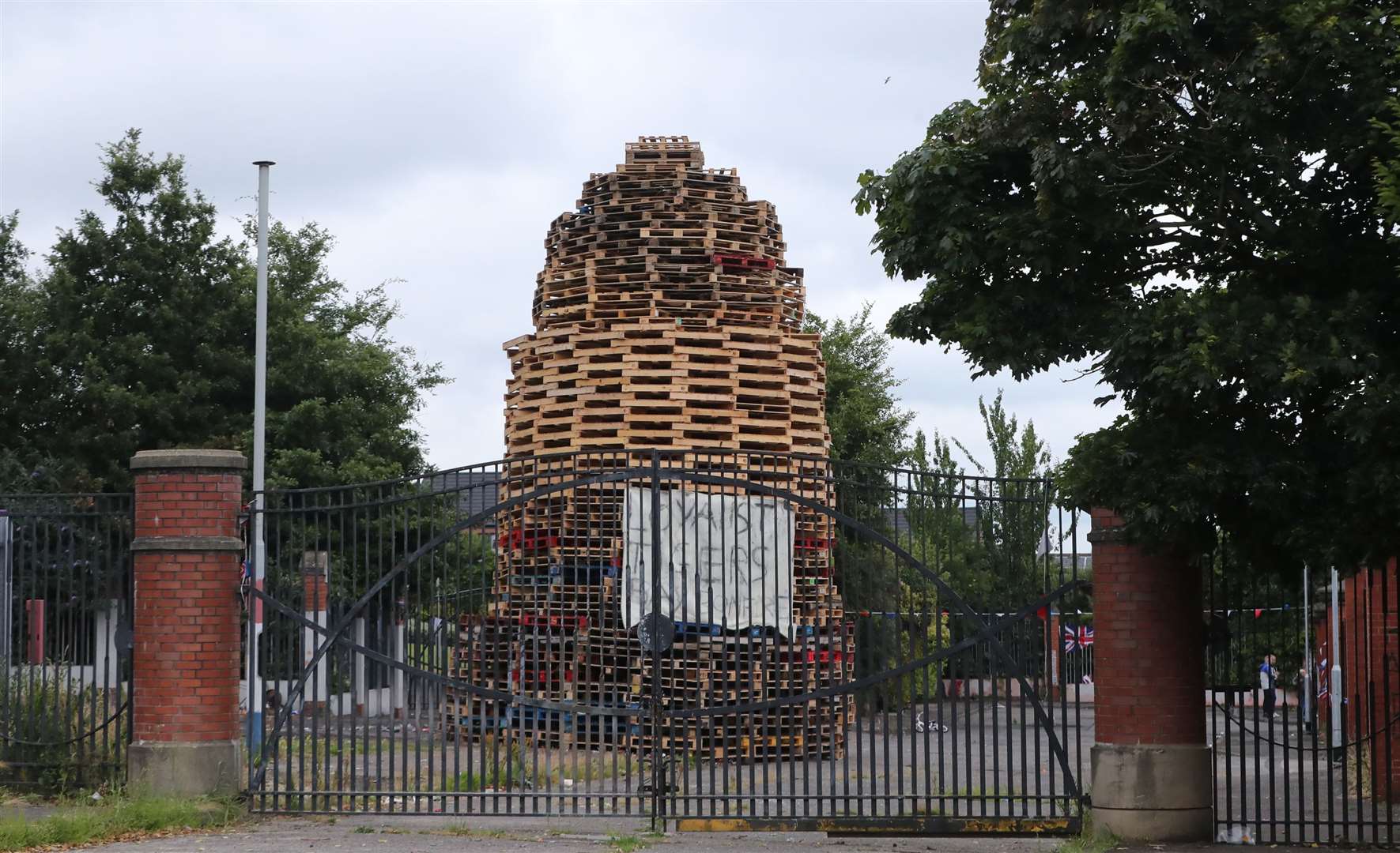 A controversial bonfire close to a peace wall in Belfast in July (Niall Carson/PA)