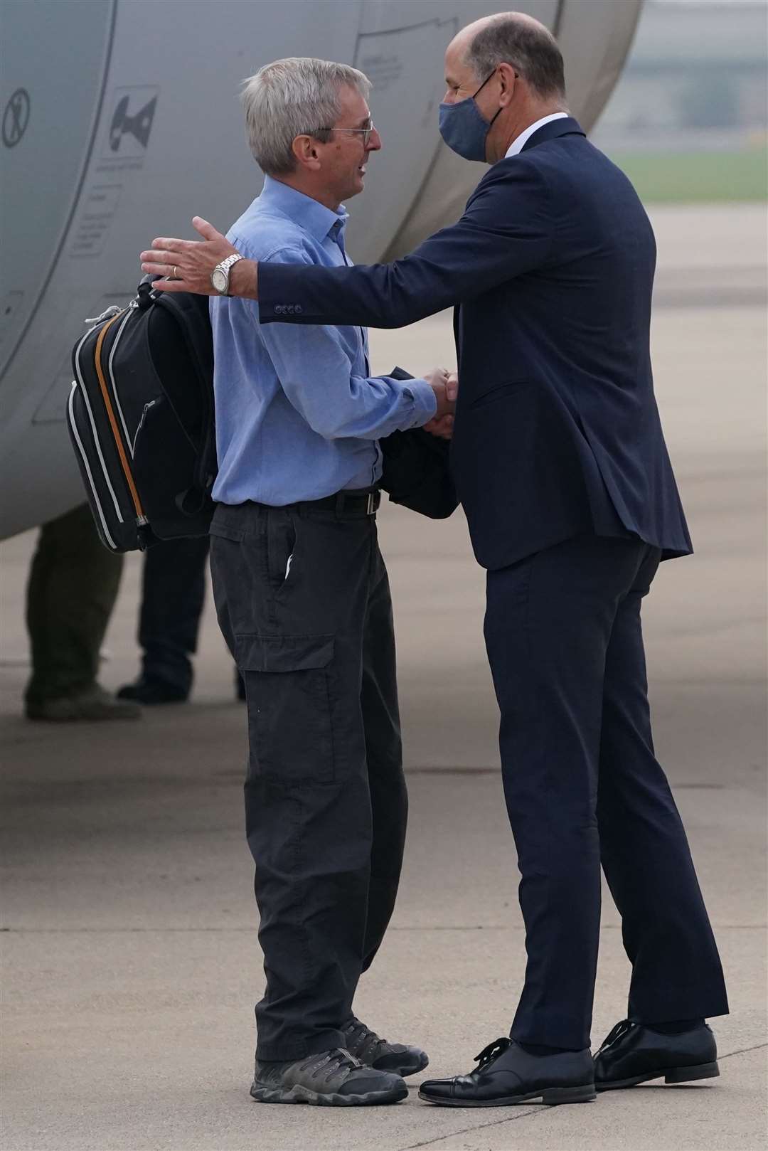 Ambassador to Afghanistan Sir Laurie Bristow, left, is greeted by Sir Philip Barton, Permanent Under-Secretary of the Foreign, Commonwealth and Development Office at RAF Brize Norton (Jonathan Brady/PA)