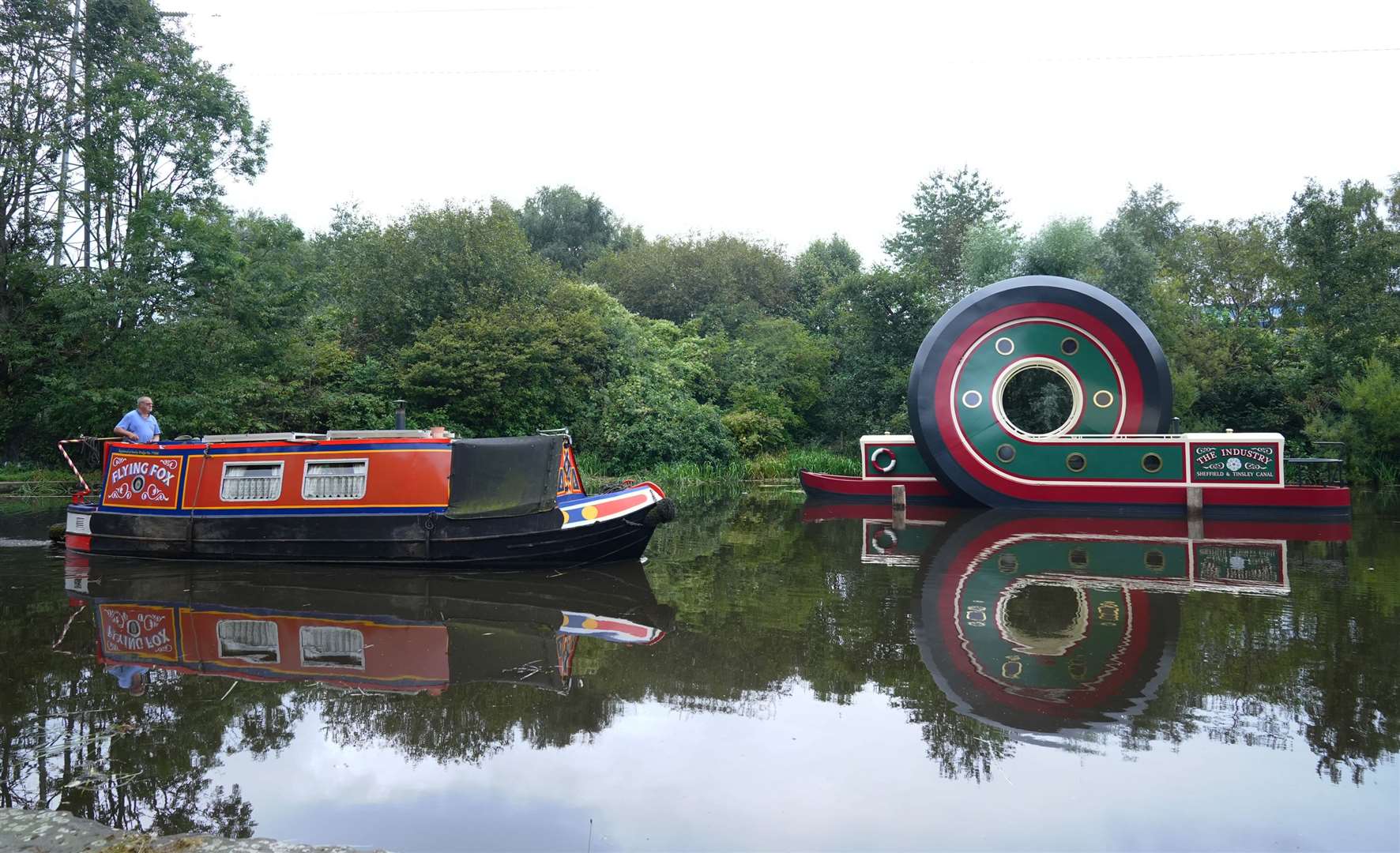 A canal boat passes the new sculpture after it was installed on the Sheffield & Tinsley Canal (Owen Humphreys/PA)