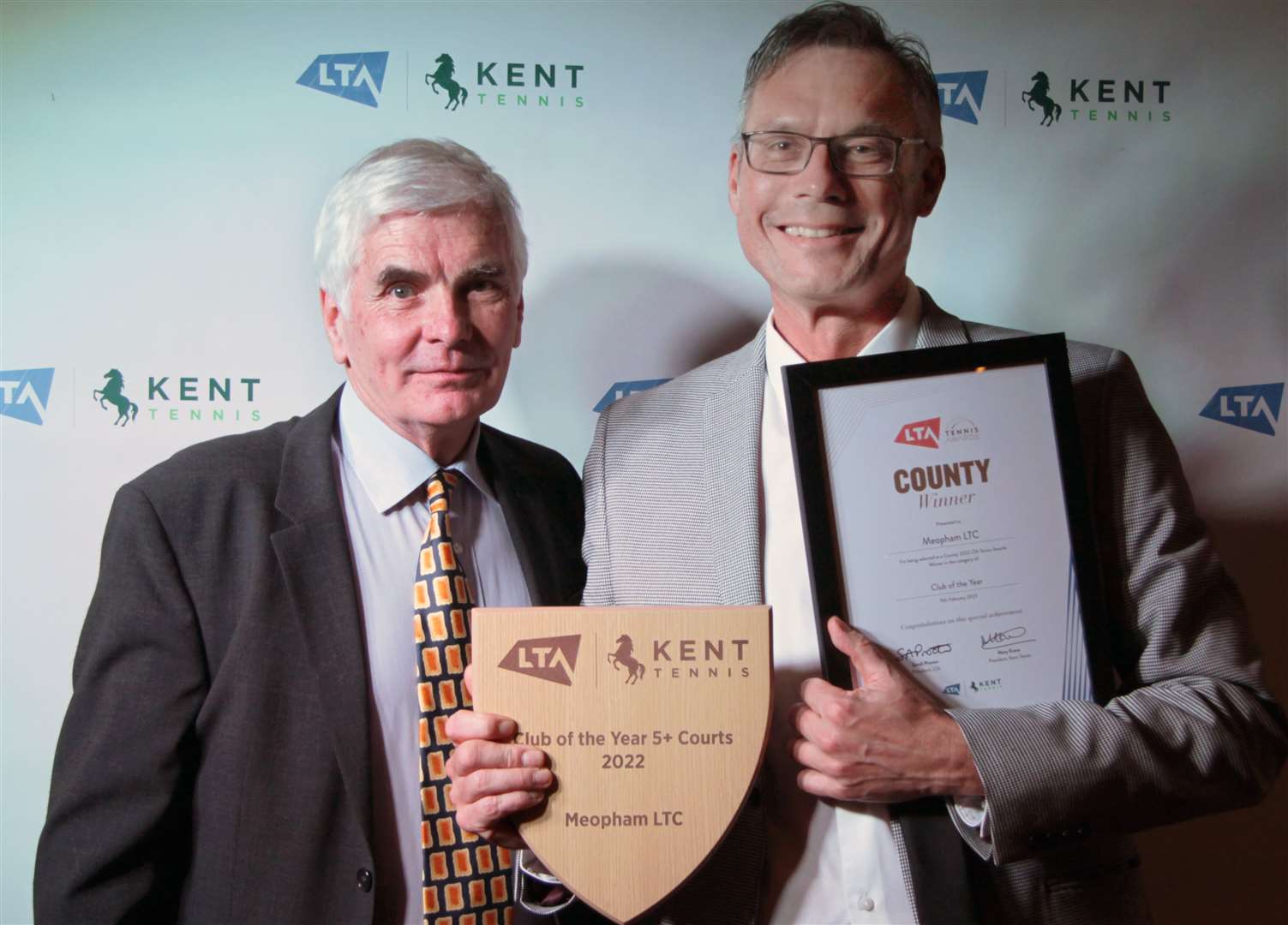 Meopham chairman Andy Candler, right, receives the Kent LTA club-of-the-year (5+ courts) award from Tim Freeman of event sponsors Trevor May Contractors