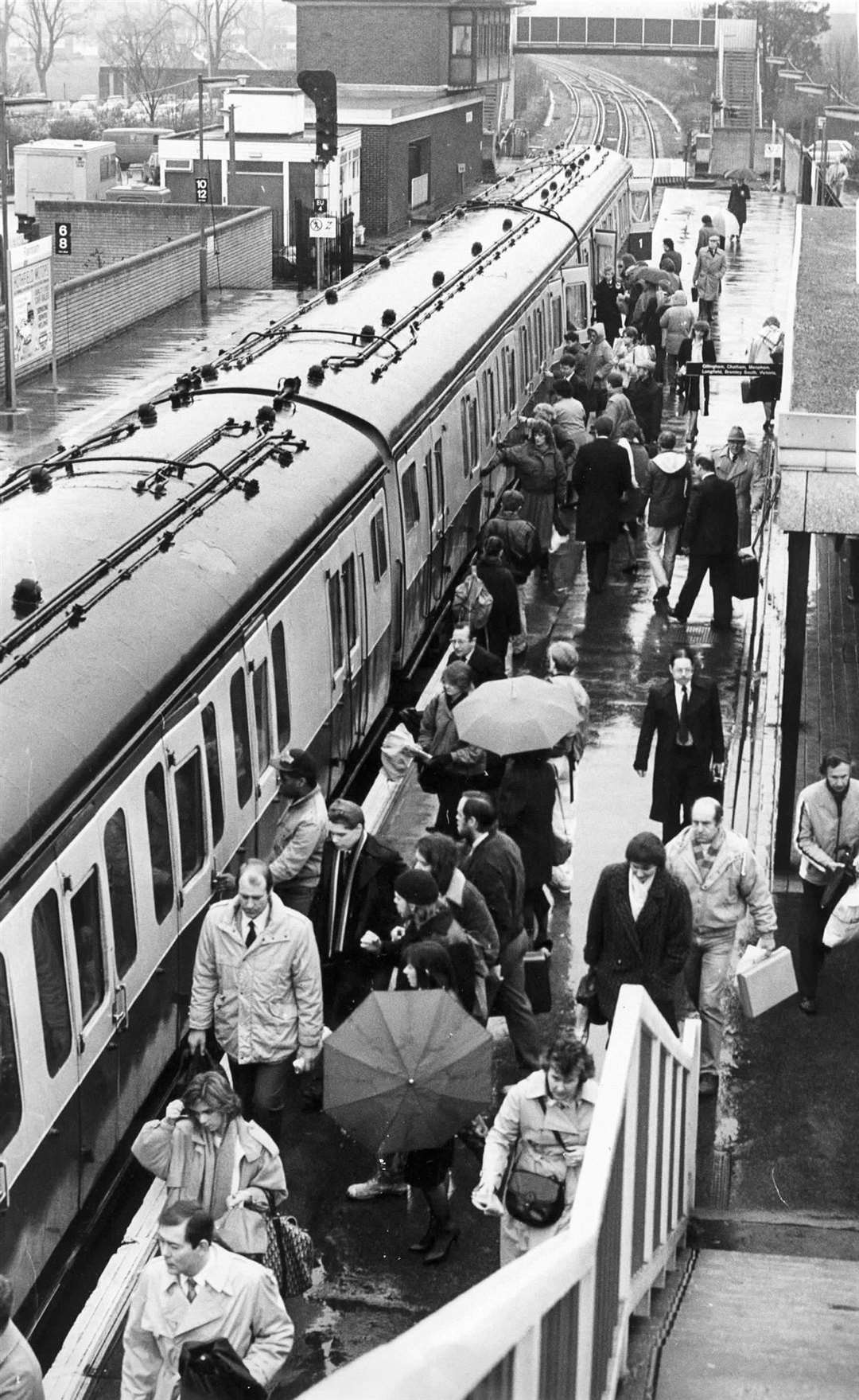 Commuters at Rainham station queue for a slow train to London at 7.45am on a wet Monday morning in March 1988