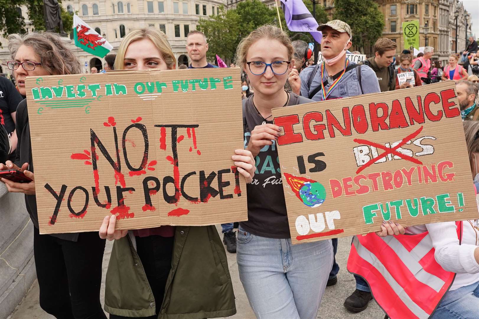 Demonstrators hold up their signs during a protest by members of Extinction Rebellion at Trafalgar Square (Stefan Rousseau/PA)