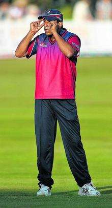 Kent's Azhar Mahmood calls for sunglasses as the low evening sun hampers the fielding side.