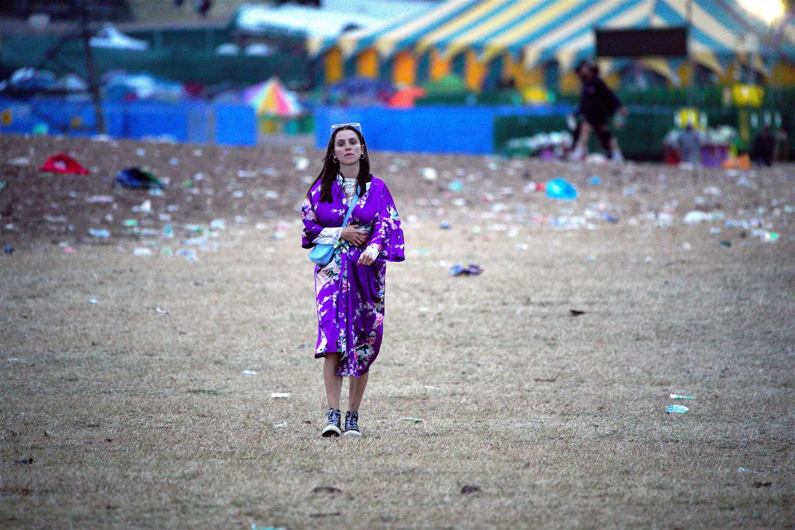 A festival-goer wanders round Worthy Farm following the festival (Ben Birchall/PA)