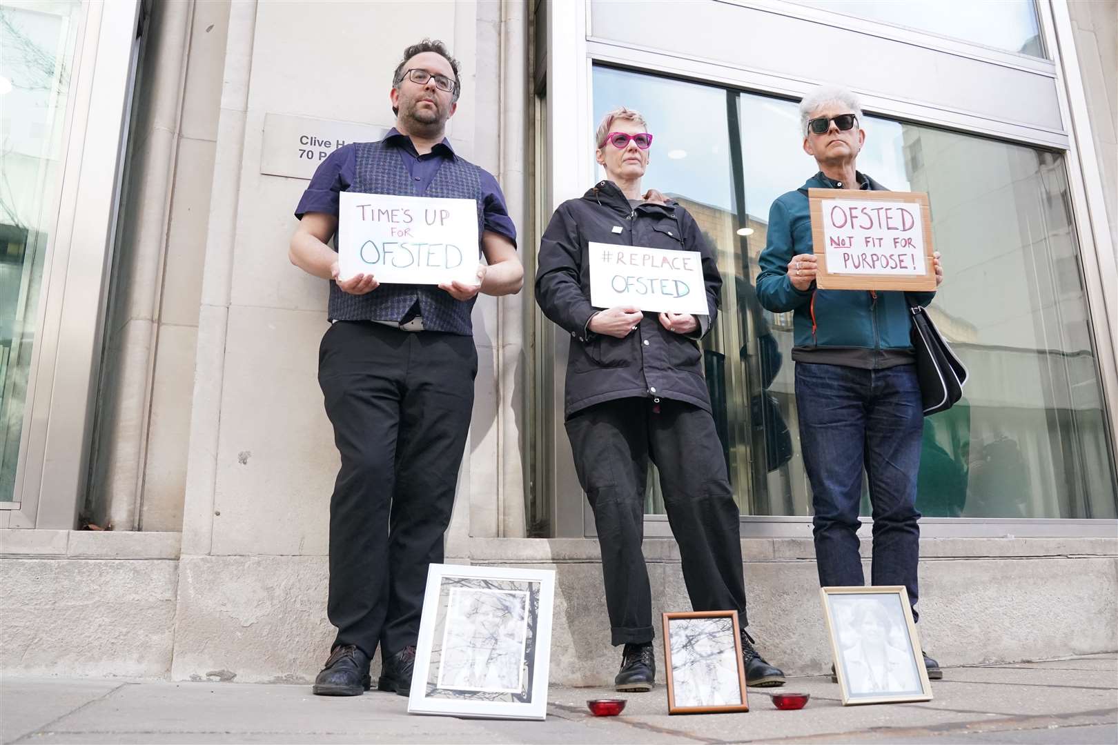 People attend a vigil in March for Ruth Perry outside the offices of Ofsted in Victoria, central London, after she took her own life while waiting for a negative Ofsted inspection report (Jonathan Brady/PA)