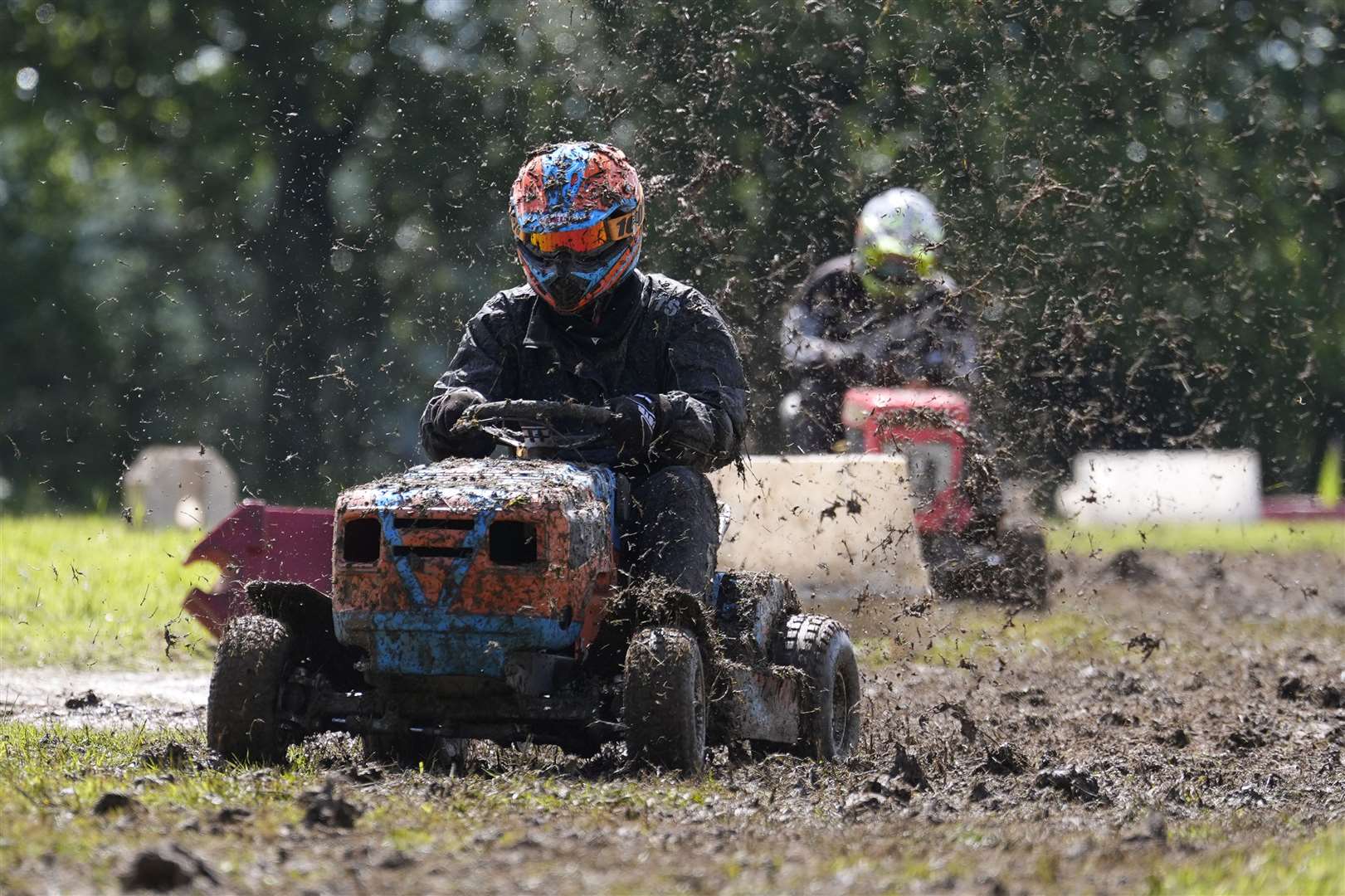 Competitors race in a heat during the World Lawnmower Championships (Andrew Matthews/PA)