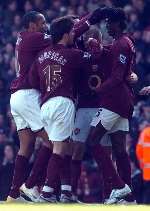 Arsenal's players celebrate Emmanuel Adebayor putting them 2-0 ahead. Picture: MATTHEW WALKER