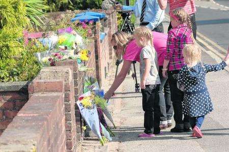 Flowers are laid at the scene of the fatal crash