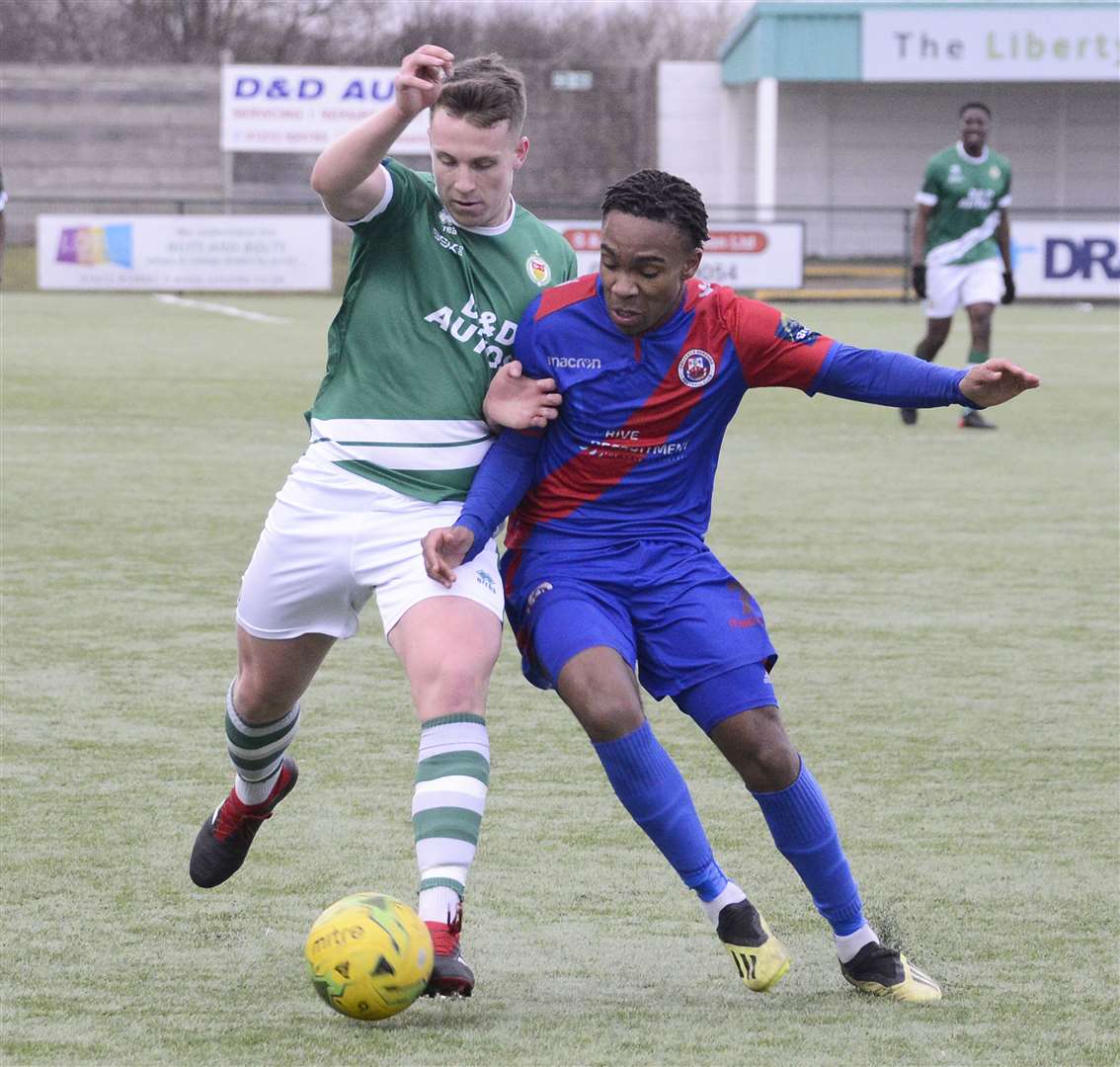 Ashford midfielder Josh Wisson gets stuck in Picture: Paul Amos