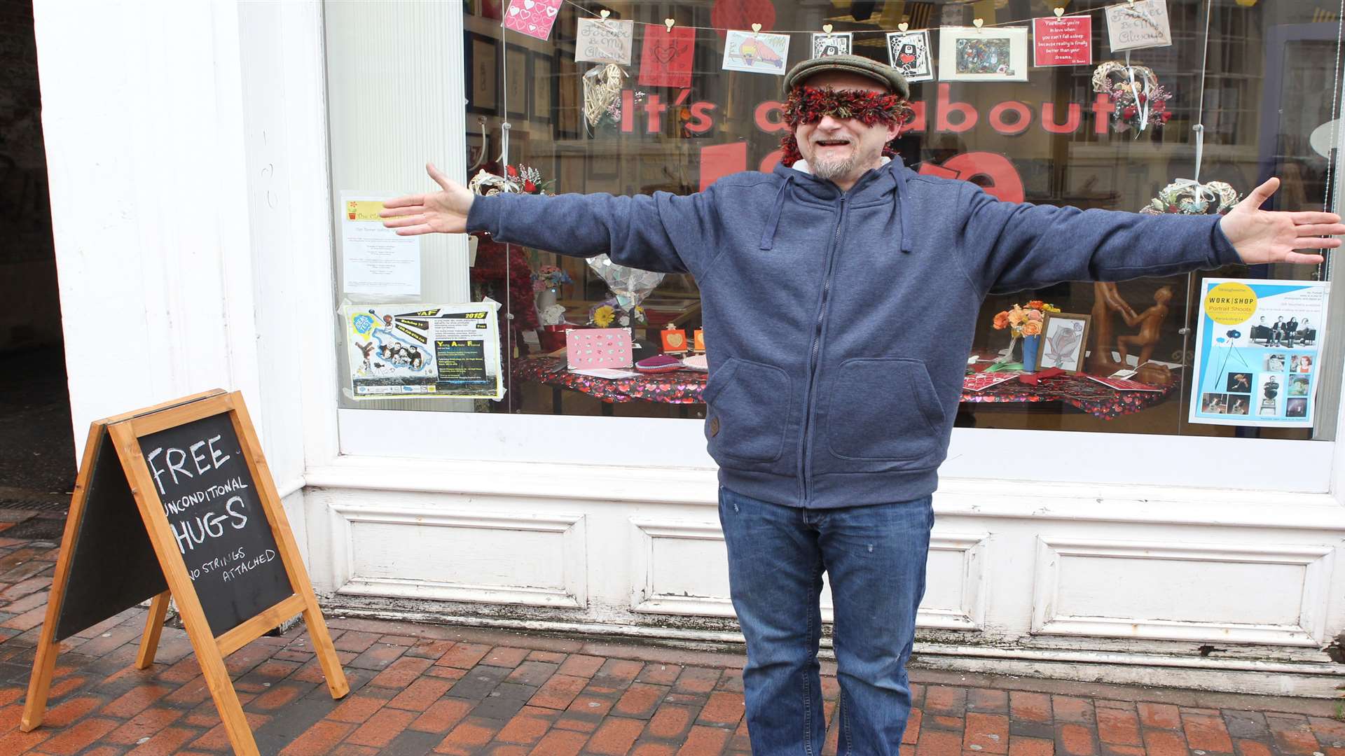 Artist Dean Tweedy performs a Valentine inspired "installation" where he offered free hugs to passerbys along Sittingbourne High Street