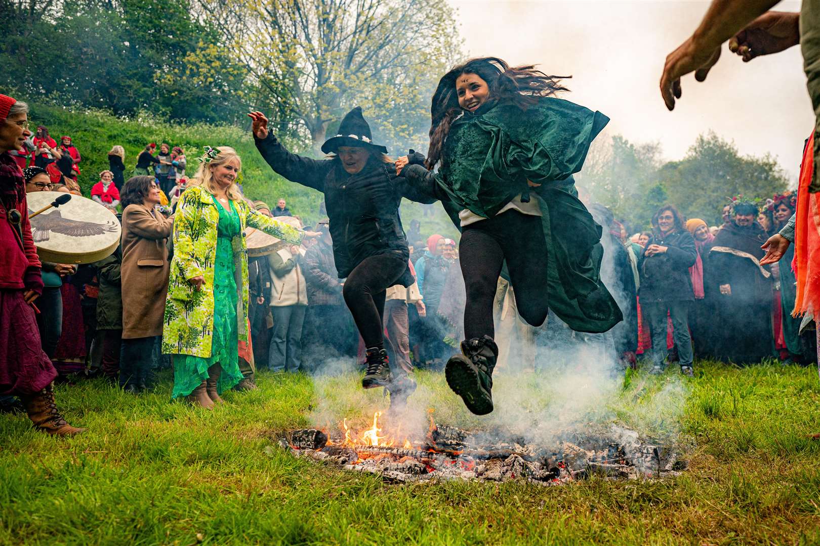 People jump the fire during the Beltane celebrations at Glastonbury Chalice Well (Ben Birchall/PA)