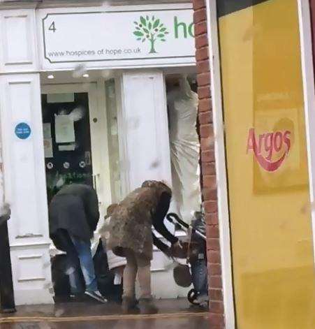 The women appear to be rifling through the bags (1553763)