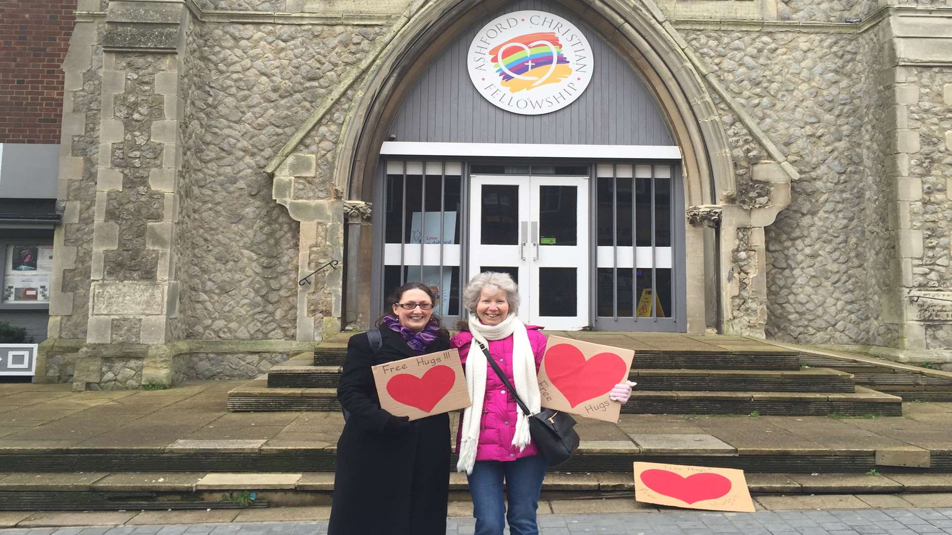 Sandra Bird and Rachel Cummings offer out their free hugs