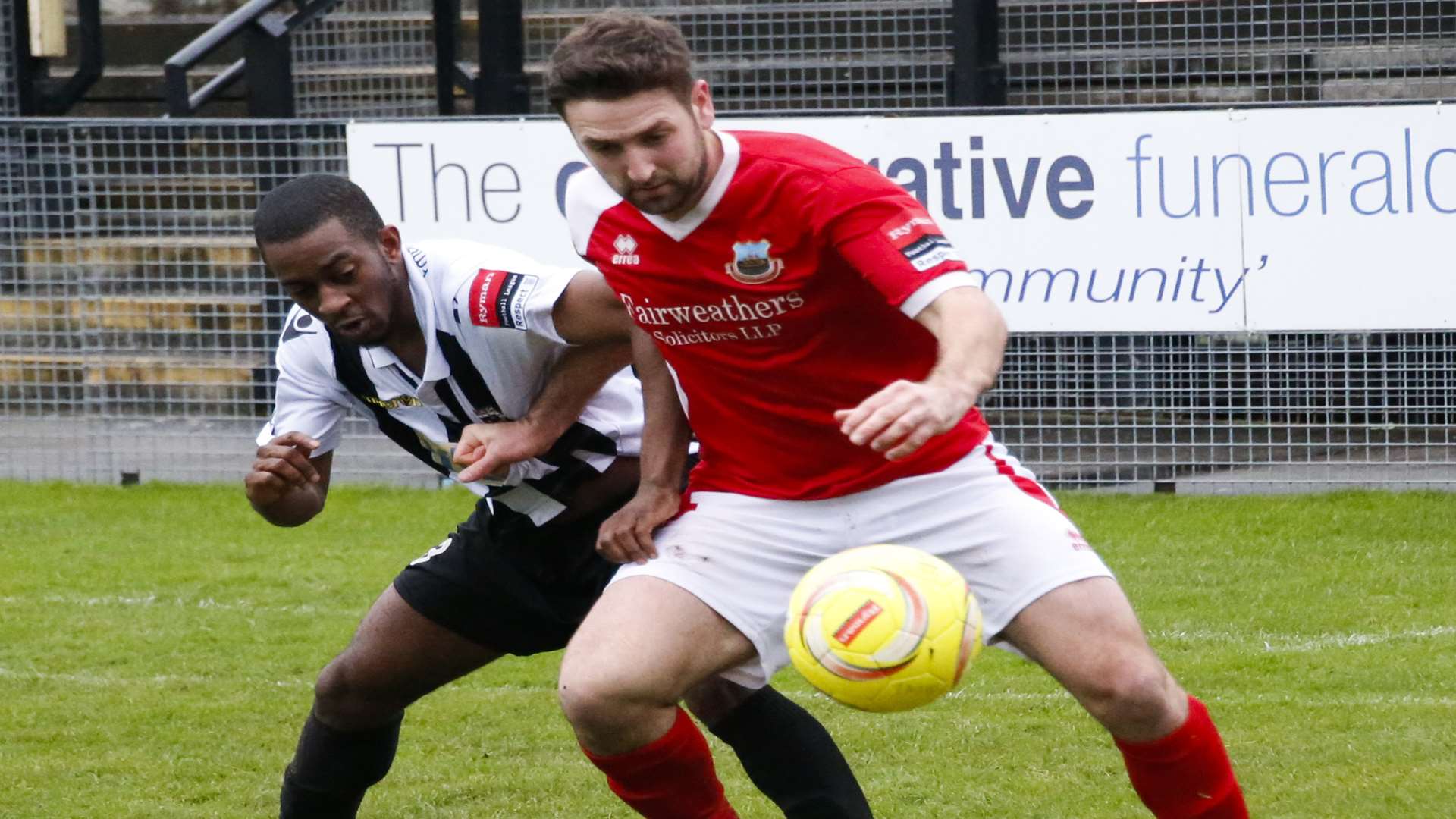 Stuart King holds off a Tooting defender Picture: Les Biggs