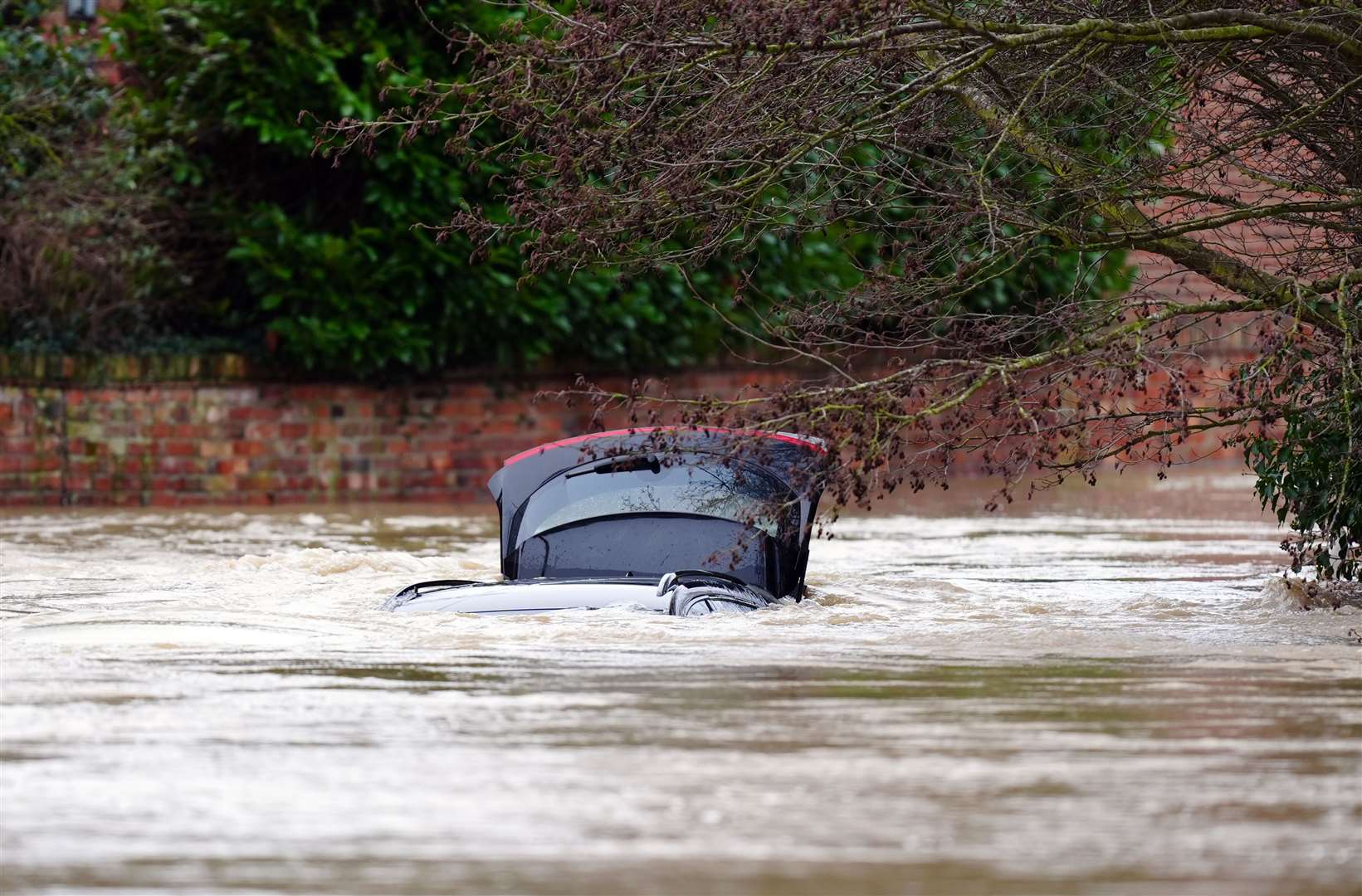 A vehicle is submerged under water near the River Devon, in Bottesford, Leicestershire (Mike Egerton/PA)