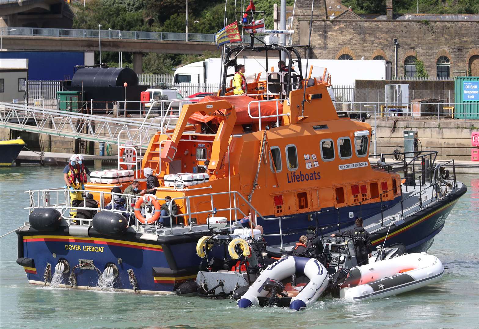 The Dover Lifeboat and Border Force officers tow small boats into the Kent port (Gareth Fuller/PA)