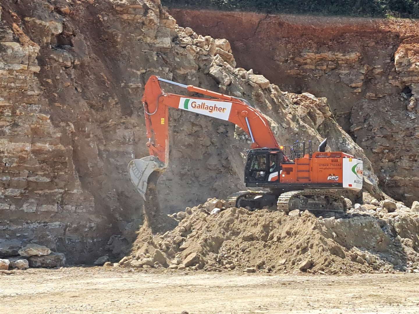 The rock is blasted away from the cliff face and then scooped up