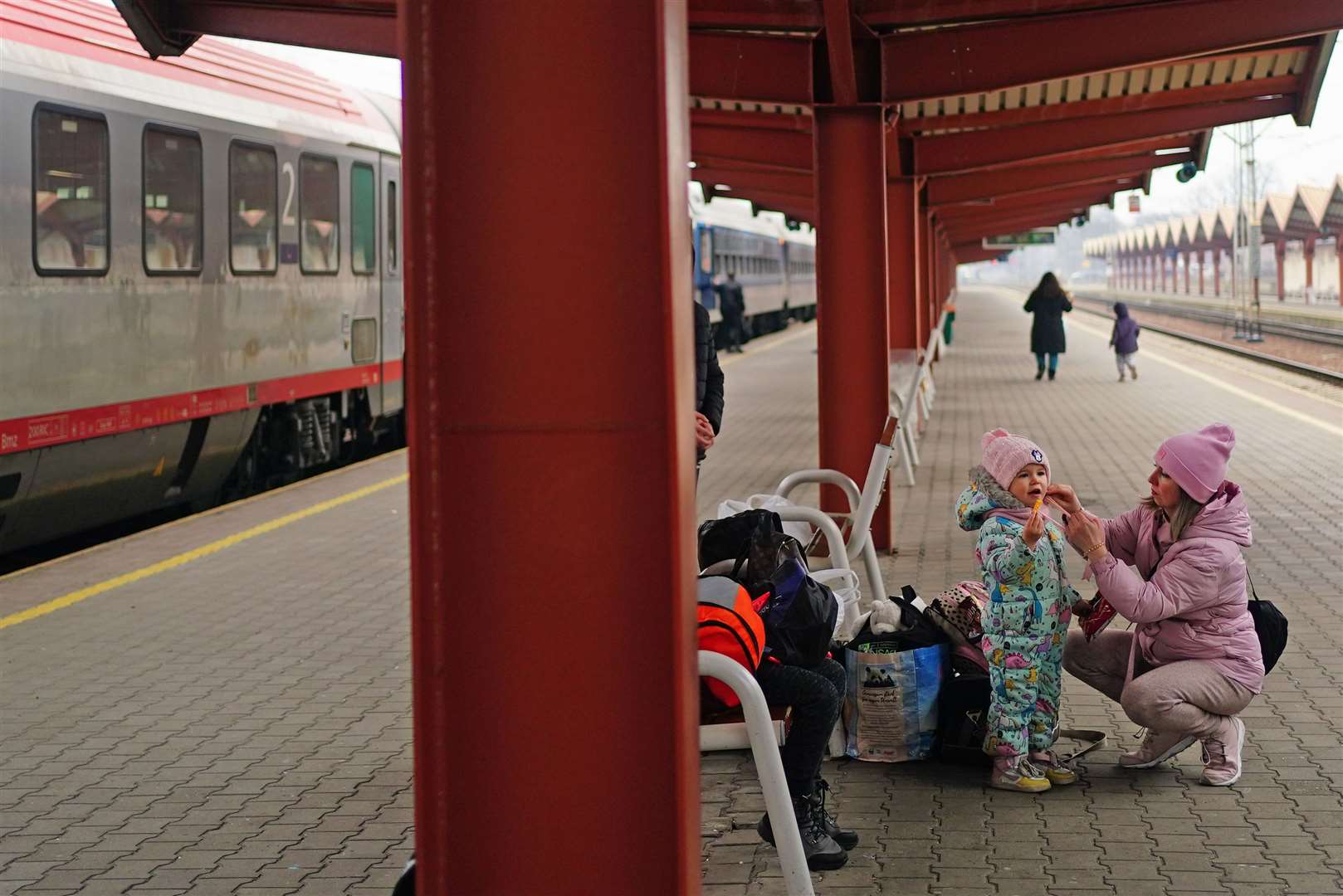 A family from Ukraine at Przemysl train station in Poland (Victoria Jones/PA)