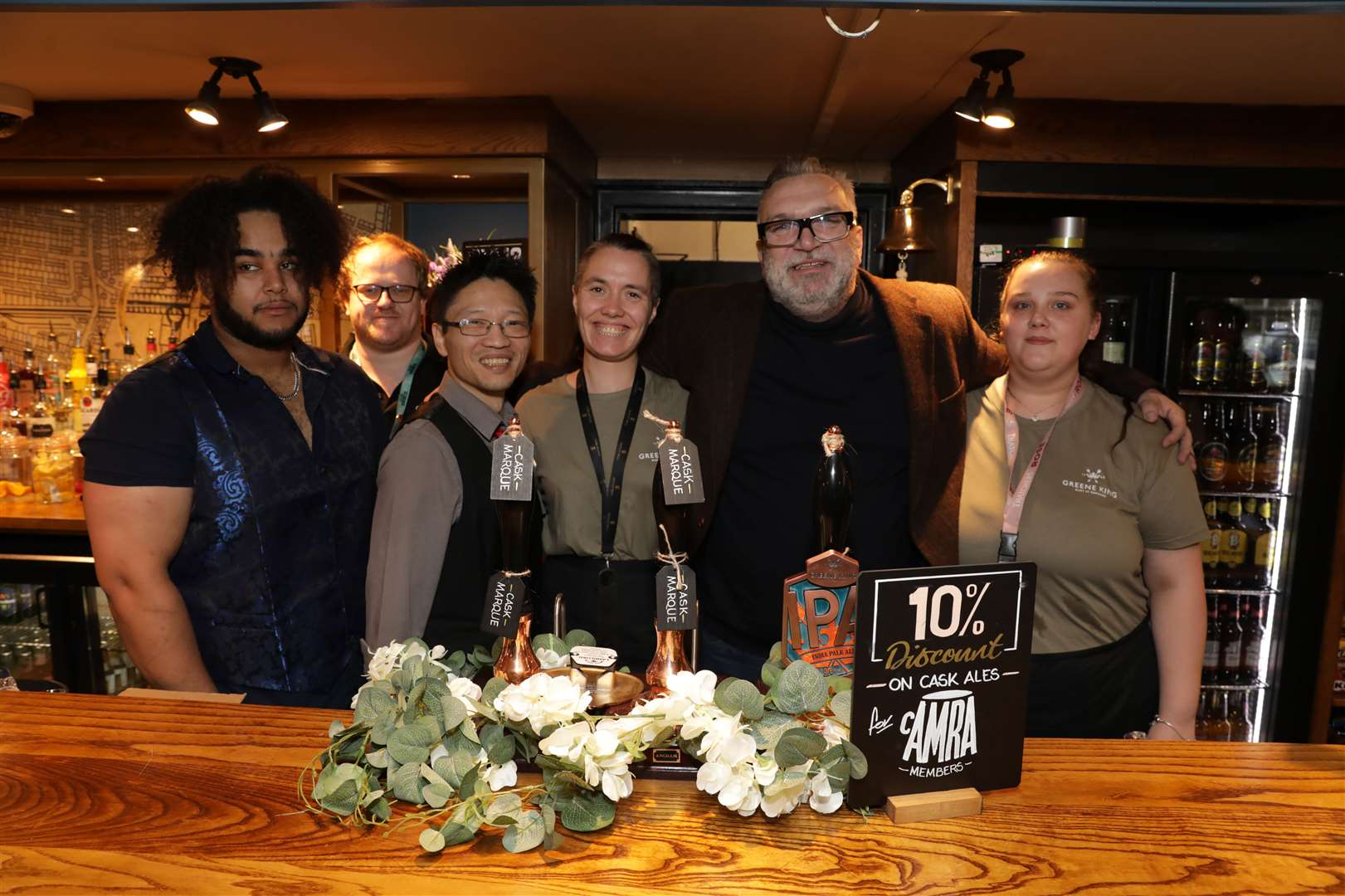 Football star Neil Ruddock joined members of staff behind the bar. From left: Kelvin, Jack, Wai, Michelle, Razor Ruddock, Amy