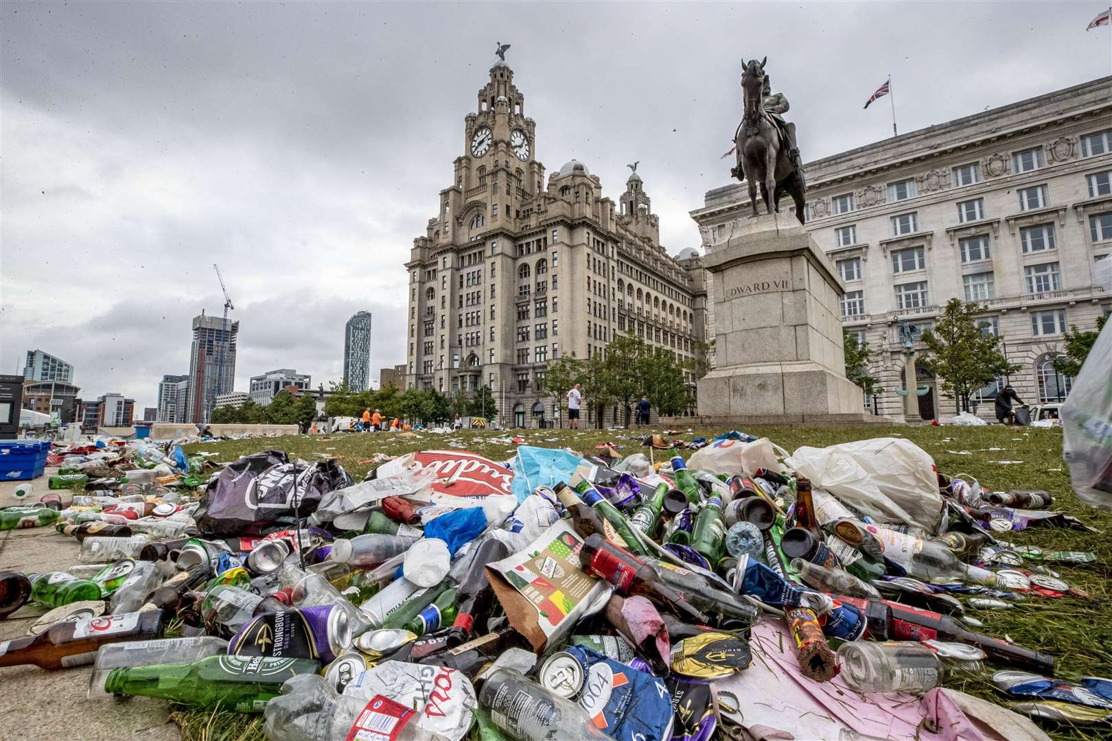 Workmen clear up rubbish left outside the Liver Building (Peter Byrne/PA)