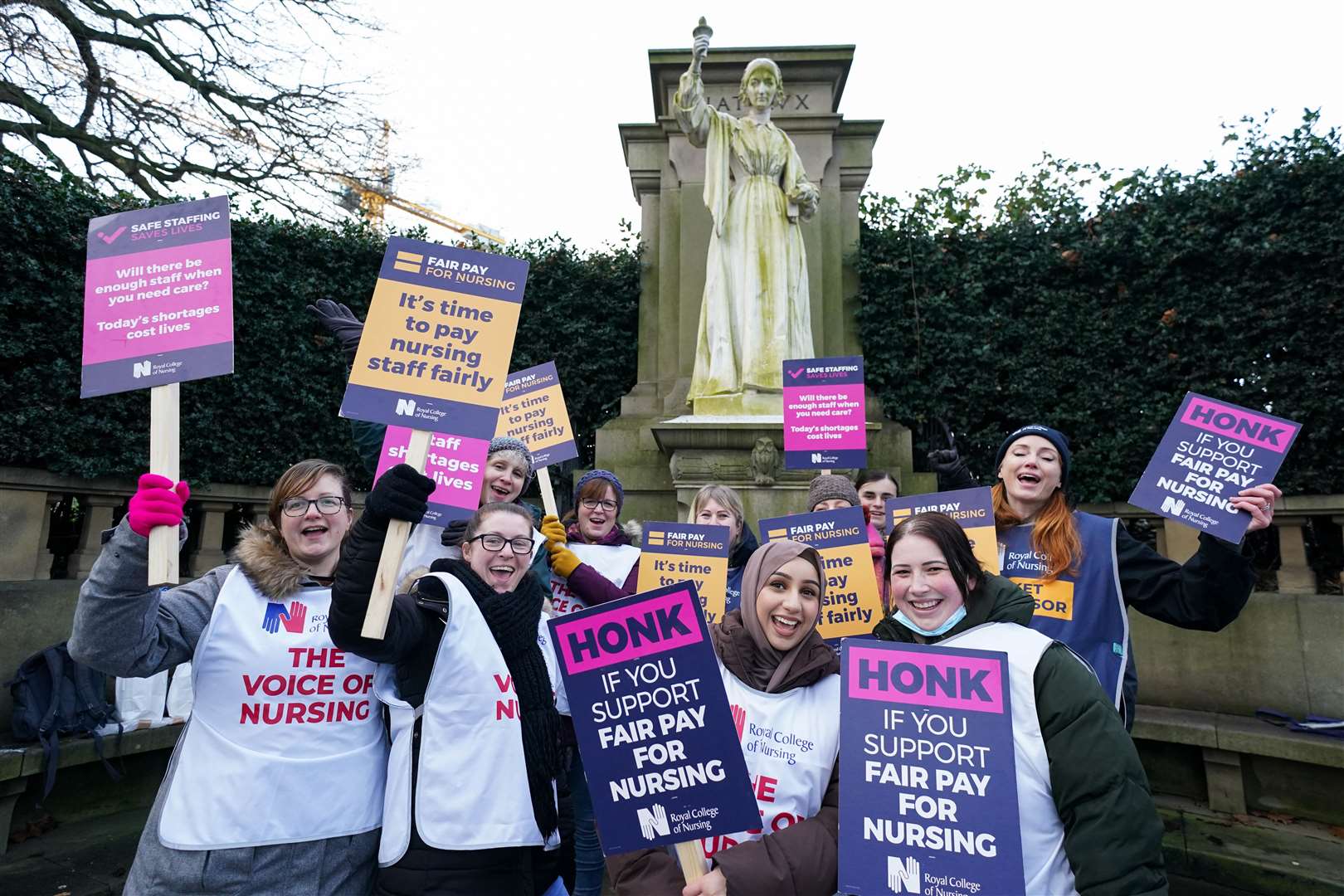 Members of the Royal College of Nursing (RCN) at the Florence Nightingale statue on the picket line near the Florence Nightingale Community Hospital in Derby (Jacob King/PA)