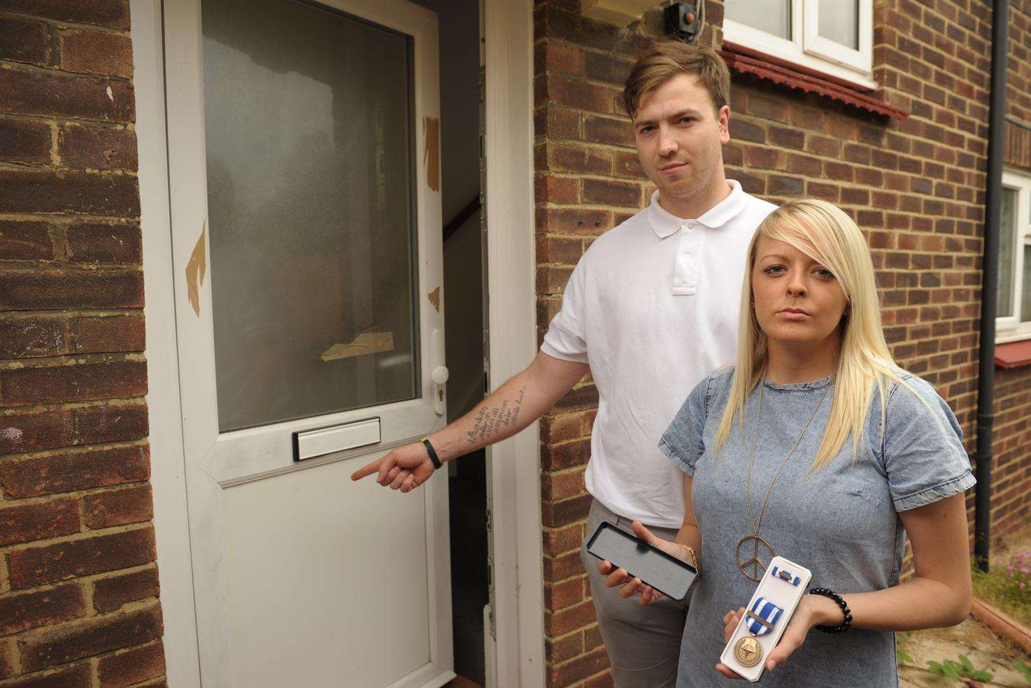 Grant Hatcher and Charlotte Howell by the kicked-in door