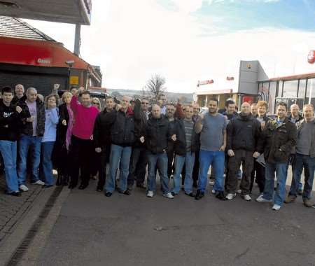 Angry staff demand answers at the dealership.