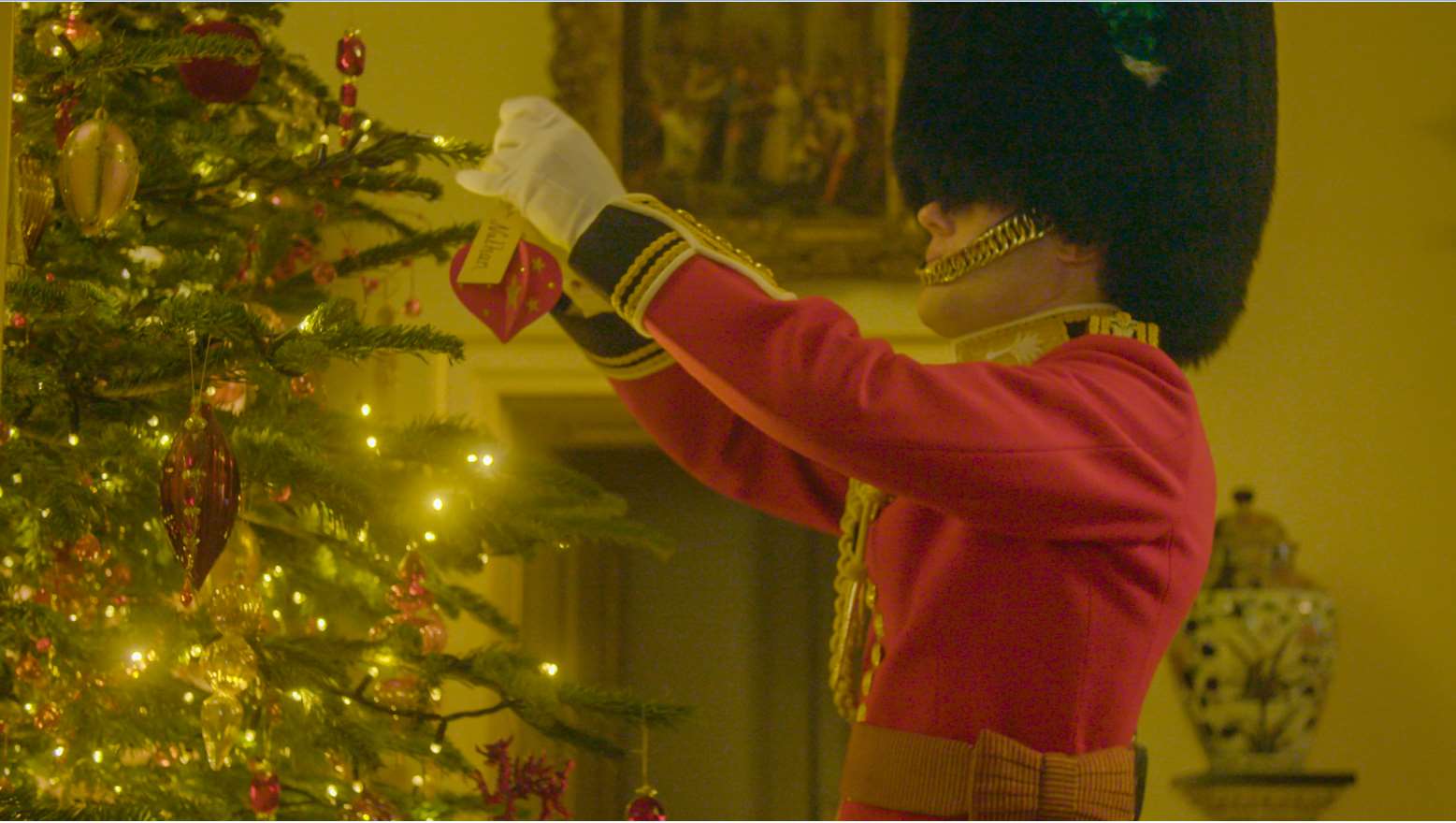 Captain Charlie Ross carefully puts the baubles on the tree (Clarence House/PA)